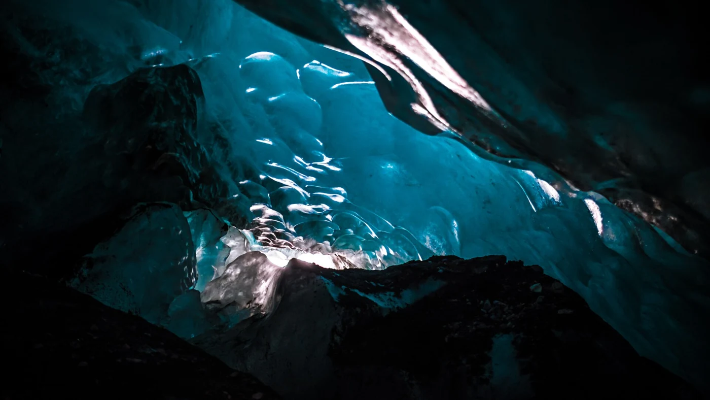 Blue ice overhead in a cave where Falljökull meets Virkisjökull near Skaftafell, on an Iceland ice cave day tour with a glacier hike
